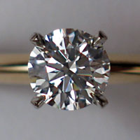 A round  diamond set in a ring.