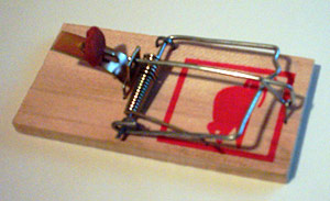 A baited and primed mousetrap.