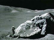  astronaut  standing next to boulder at Taurus-Littrow during third EVA
