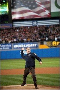 Donning a bullet-proof vest, President Bush tosses out the ceremonial first pitch.