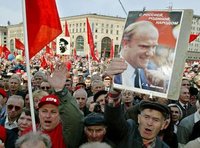A demonstrator carries a portrait of Gennady Zyuganov in a 2003 demonstration against the Putin government. The placard says "Zyuganov: With Russia, Motherland, and the People."