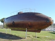 A replica of 's wooden Ictineo II stands near  harbor