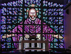 Stained glass in Buckfast Abbey. The panel is about 8 metres (26 feet) across and was designed by the monks who built the abbey