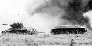 A Soviet  tank towing a damaged armoured vehicle at the  in July 1943. The Soviet Union manufactured 40,000 T-34s during the war.