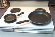 Cooking pans are typically circular, with handles, and come in a variety of sizes