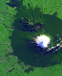 Satellite picture of Mount Taranaki from the NASA Earth Observatory showing the nearly-circular Egmont National park surrounding it.