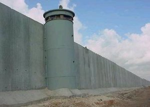 A section of the Israeli West Bank barrier between  and the nearby Israeli highway. This section of the barrier is on the  line. Since this section was built, incidents of Palestinian  from Qalqiliyia shooting at Israeli civilian cars have ceased. However, ordinary Palestinians have also lost access to their farmlands and to surrounding towns and villages.