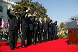 The U.S. President, NATO Secretary General, and the Prime Ministers of Slovenia, Lithuania, Slovakia, Romania, Bulgaria, and Estonia after a South Lawn ceremony welcoming them into NATO on March 29, 2004.