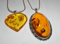 Amber pendants. The oval pendant is 52 by 32 mm (2 by 1.3 inches).