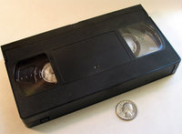 Top view VHS cassette with US Quarter for scale