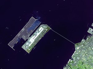 Satellite closeup of the airport and its bridge. Construction of the second runway-island is underway. Rinku Town is visible on the mainland.