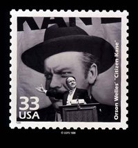 Citizen Kane, directed by and starring , is here commemorated on a .  In this famous scene Kane gives a political speech with a giant portrait of himself in the background.