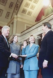 Hillary Clinton is sworn in as a U.S. Senator by Vice President Gore as Bill and  look on.