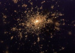 London by night as seen from the . The   can be seen ringing the city, most notable here to the south, and two dark spots on the edge of the densely packed lights of  are just noticeable in this thumbnail view:  and .