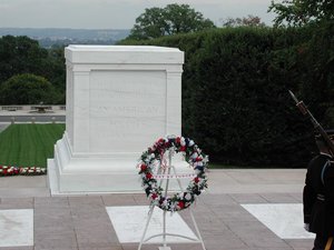 The Tomb of the Unknowns. The World War I unknown is below the marble sarcophagus. The other unknowns are beneath the white slabs on the ground. They are (from left to right) the World War II unknown, the Vietnam unknown, and the Korean War unknown