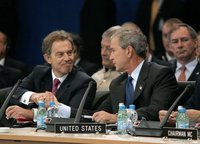 Blair shakes hands with President Bush on  , on the day  became Interim Prime Minister of 