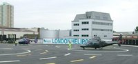 Helicoptors parked with rotors turning, at the London Heliport