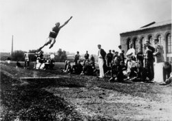 Owens setting the world record in the long jump at the  in 1935